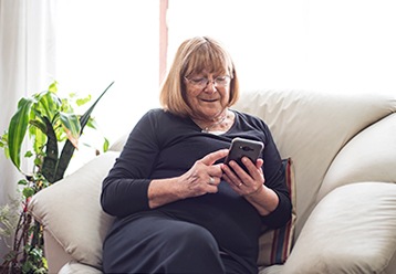 Image of older woman looking at phone
