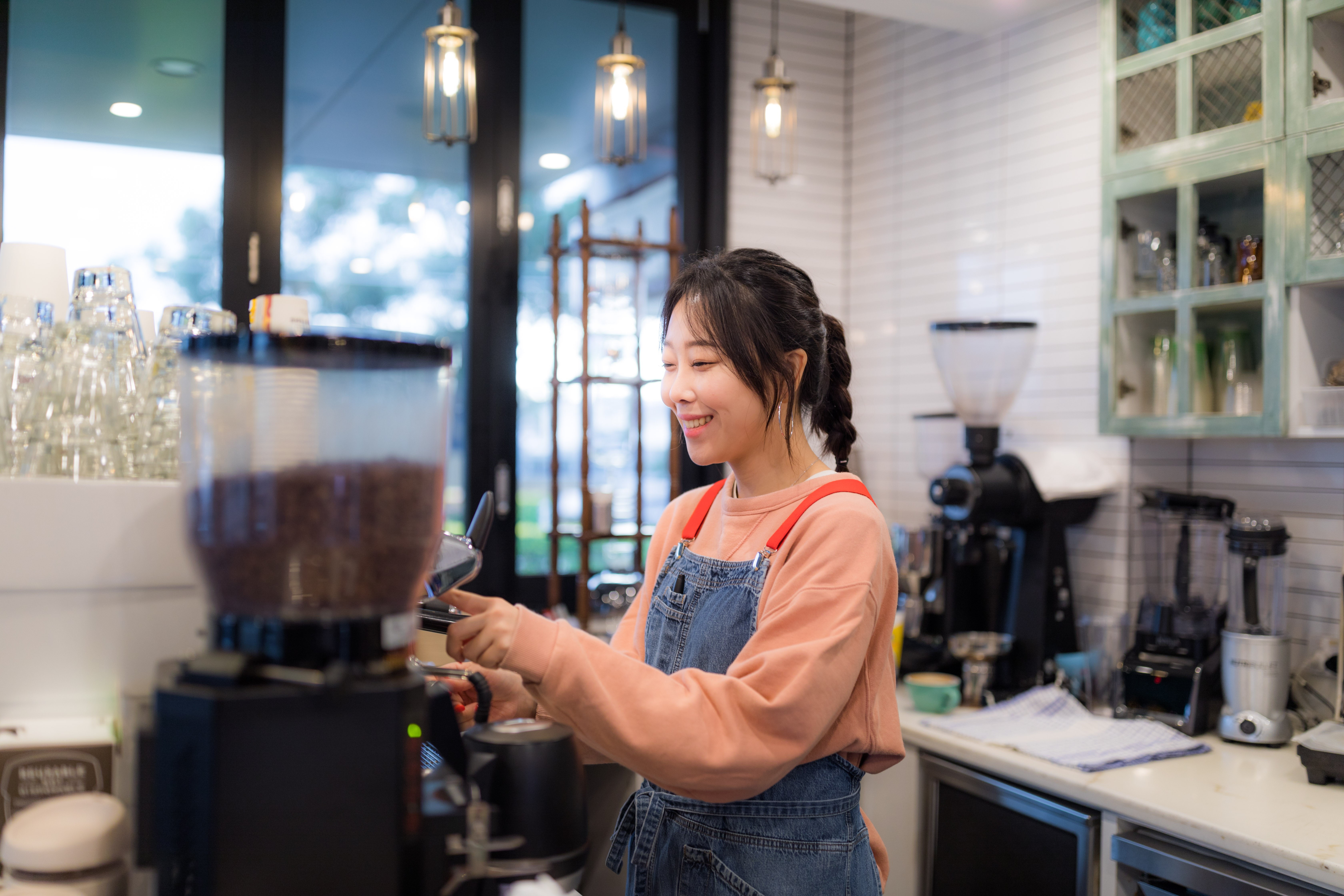 Woman making a coffee in a cafe