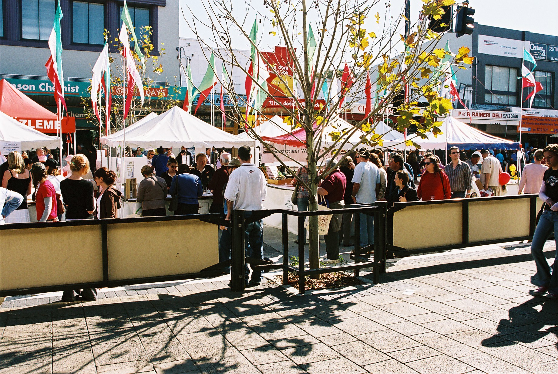 crowd of people in front of white stall