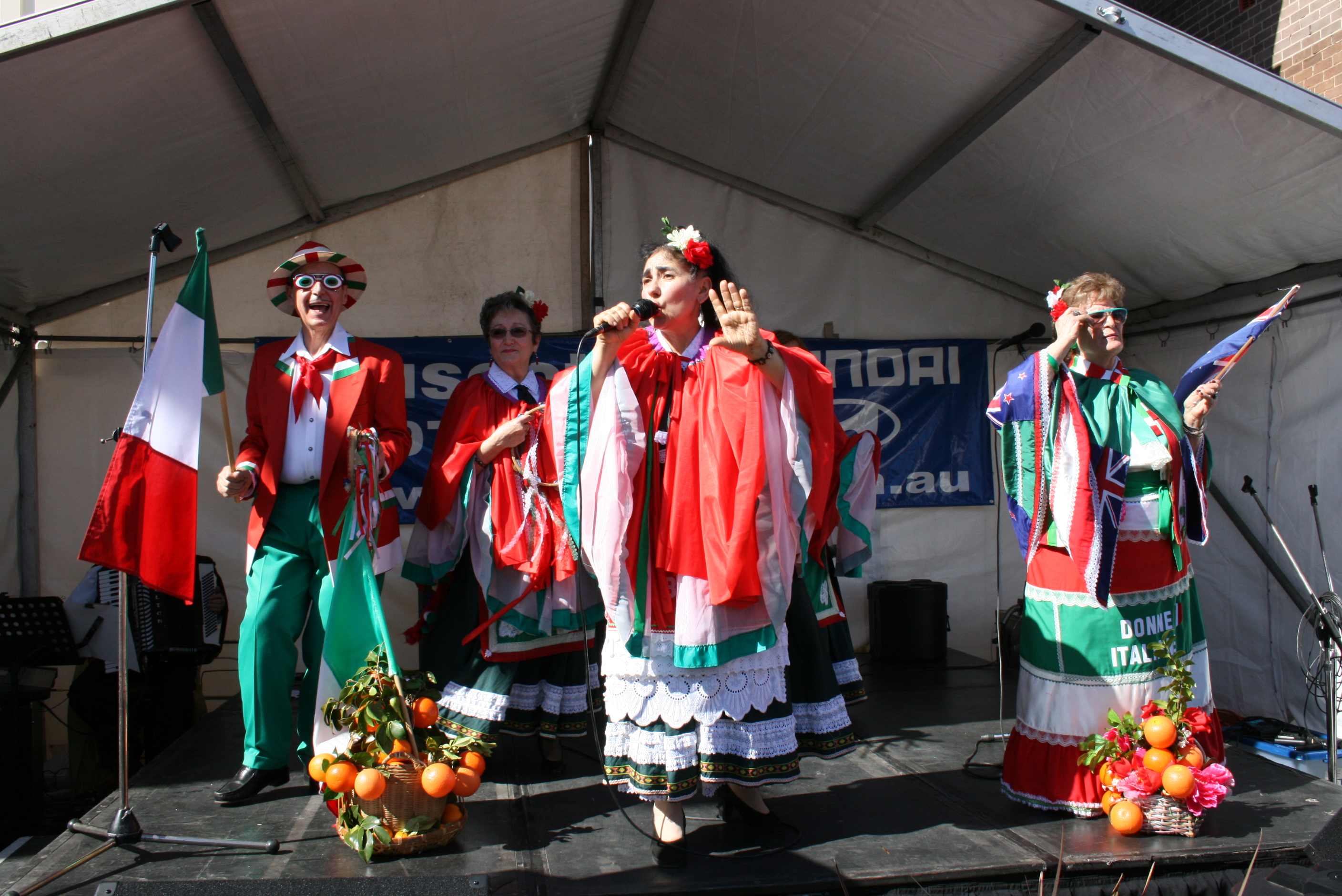 people in italian colours singing on stage