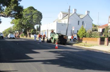 Image of Council workers resurfacing an asphalt road
