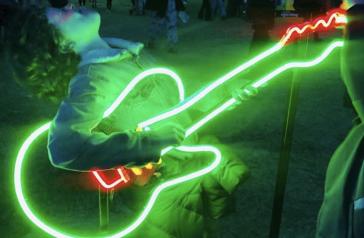 Child with guitar neon light installation