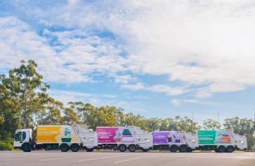 Four waste collection trucks featuring newly designed livery.