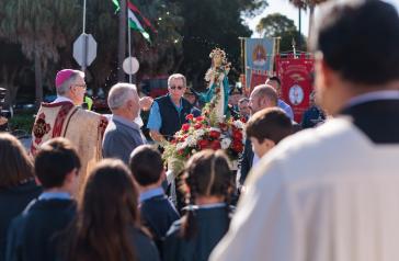 Bishop Meagher and a statue of Mary at the Lady of the Assumption Procession 2022