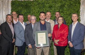 Group standing in front of an award