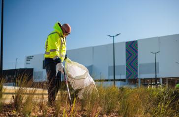 Council staff member collecting rubbish at Concord Oval Community and Sports Precinct