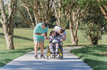   Canada Bay local Adam with daughter Isabel and her carer Verity enjoying the new accessible pathways at Majors Bay Reserve